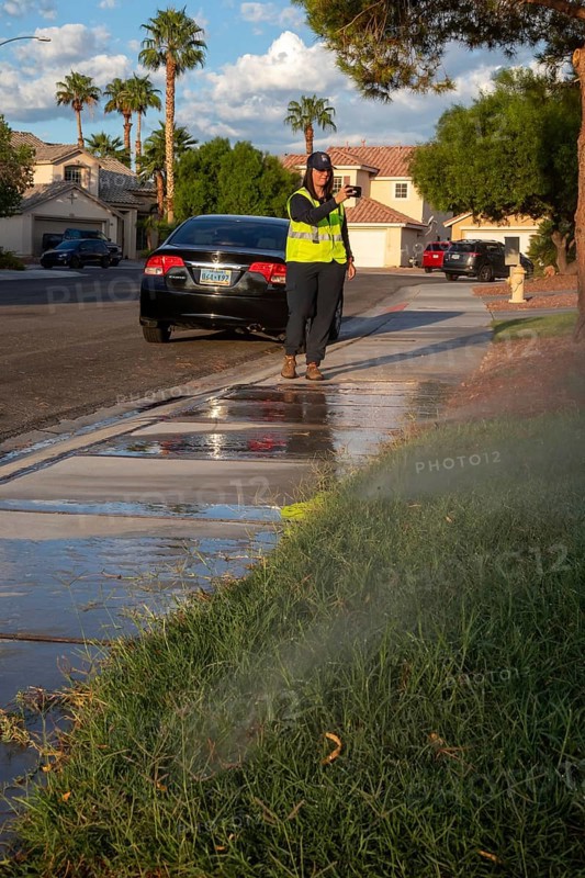 Las Vegas, Nevada - Devyn Choltko, a water waste investigator, patrols a residential neighborhood, recording and issuing tickets for illegal water use. The Las Vegas Valley Water District has cut usage of scarce Colorado River water by more than 30% over the last 20 years despite a growing population