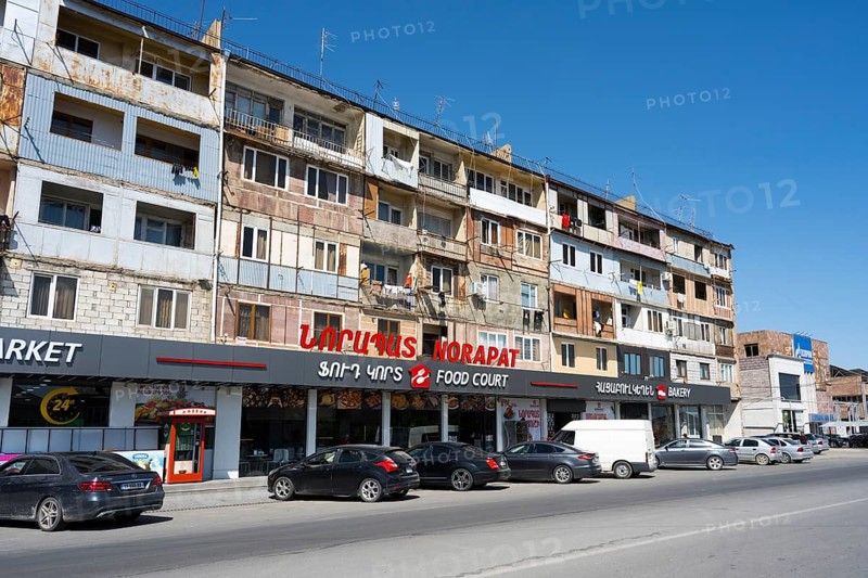 A multi-storey residential building with shops on the ground floor on a busy street, Norapat, Armavir Province, Armenia