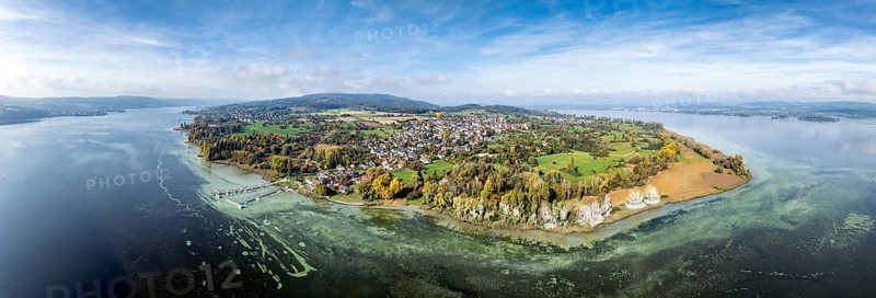 Aerial view, panorama of the Höri peninsula with the headland, called Hornspitze, nature reserve, behind it the village of Horn, on the right on the horizon the town of Radolfzell on Lake Constance, on the left Lake Rhine with the Swiss lakeshore, Gaienhofen, district of Constance, Baden-Württemberg, Germany