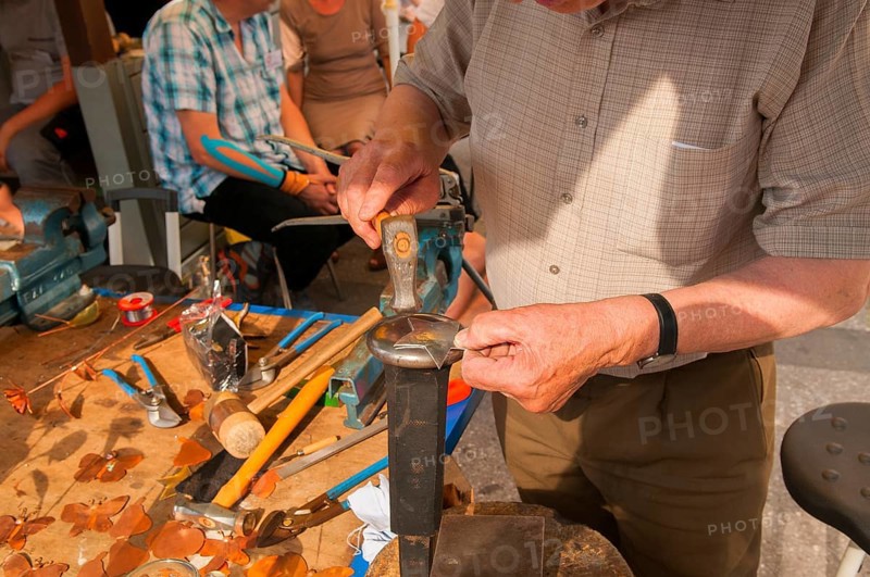 Tinsmith at work, old trade, tinsmiths or plumbers are craftsmen who take care of metal products. City festival, Munich, Bavaria