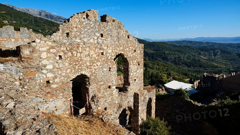 Ruins on a hill overlooking a vast mountain landscape under a clear blue sky, Mystras, Mistra, UNESCO World Heritage Site, Medieval Byzantine ruined city, northwest of Sparta, foothills of the Tyagetos Mountains, Peloponnese, peninsula, Greece