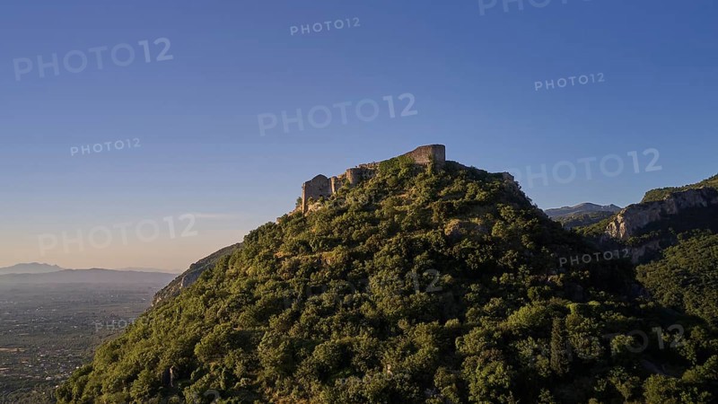 Byzantine castle from the 13th century AD on a green hill in the sunrise, surrounded by forest, Mystras, Mistra, UNESCO World Heritage Site, Medieval Byzantine ruined city, northwest of Sparta, foothills of the Tyagetos Mountains, Peloponnese, peninsula, Greece