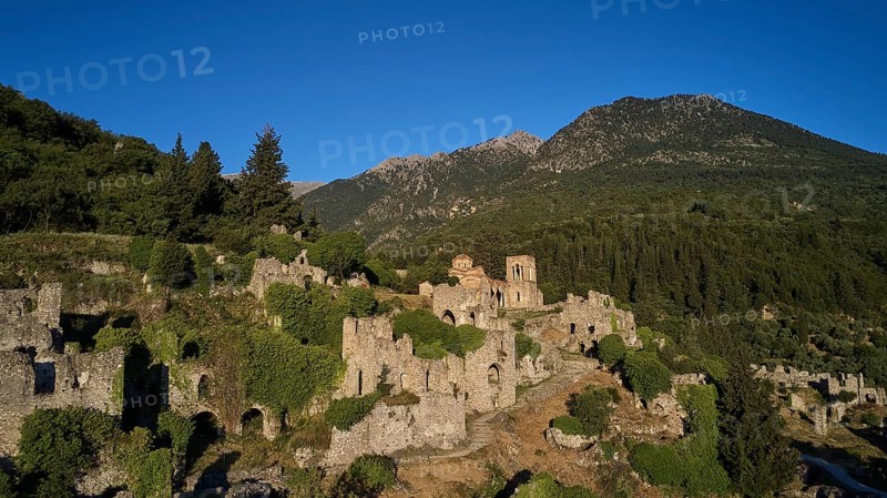 Drone shot, Historical ruins in a hilly landscape with a clear blue sky, Church of Agia Sophia from the 14th century AD, Mystras, Mistra, UNESCO World Heritage Site, Medieval Byzantine ruined city, northwest of Sparta, foothills of the Tyagetos Mountains, Peloponnese, peninsula, Greece