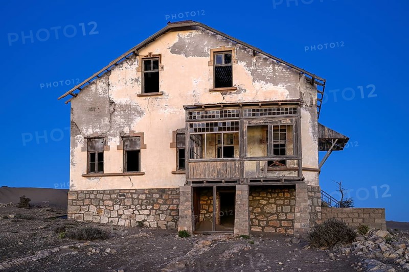 Dilapidated building in the desert sand, blue hour, Kolmanskop, near Lüderitz, Karas region, Namibia