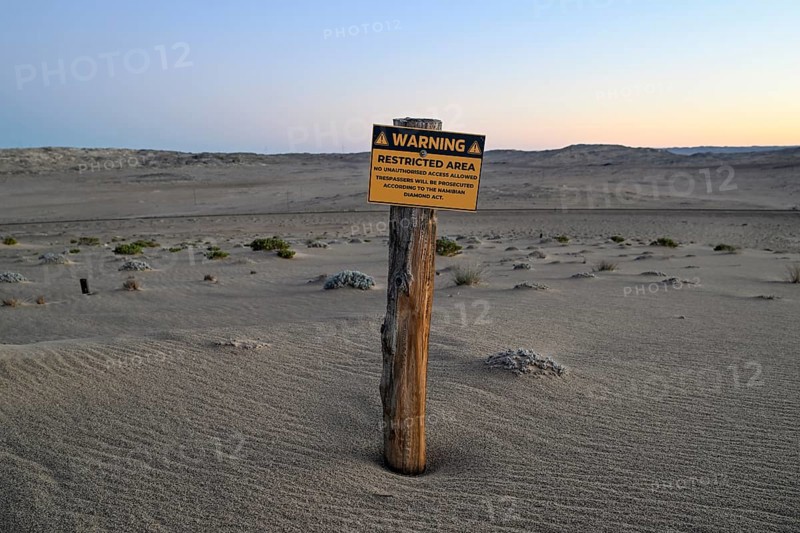 Restricted Area sign in the desert sand, Kolmanskop, diamond restricted area, near Lüderitz, Karas region, Namibia