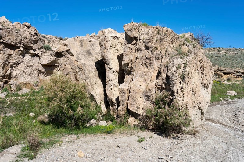 Rough rocky area with little vegetation and blue sky above, Stone Book, landscape near Dashtakar, Ararat Province, Armenia