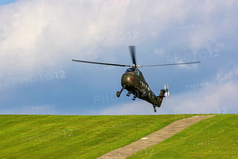 A Sikorsky S-58C transport helicopter in the colours of the German Army with the registration D-HAUG during a flight demonstration as part of an air show at the Rossfeld in Metzingen-Glems, Baden-Württemberg, Germany, for editorial use only