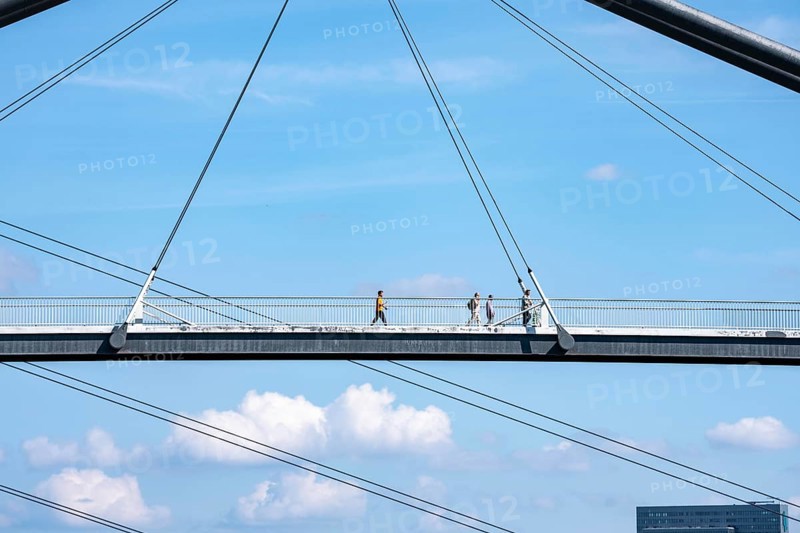 Bridges in Düsseldorf, in the foreground, the pedestrian and cycle bridge over the canal to the inner harbour, media harbour of Düsseldorf, behind it the Rheinkniebrücke, road bridge over the Rhine near Düsseldorf, Germany