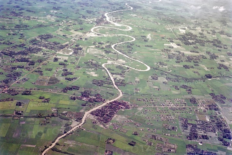Captioned as 'aerial photo Saigon', meandering river in flat agricultural landscape of paddy fields, Vietnam, south east Asia c 1964