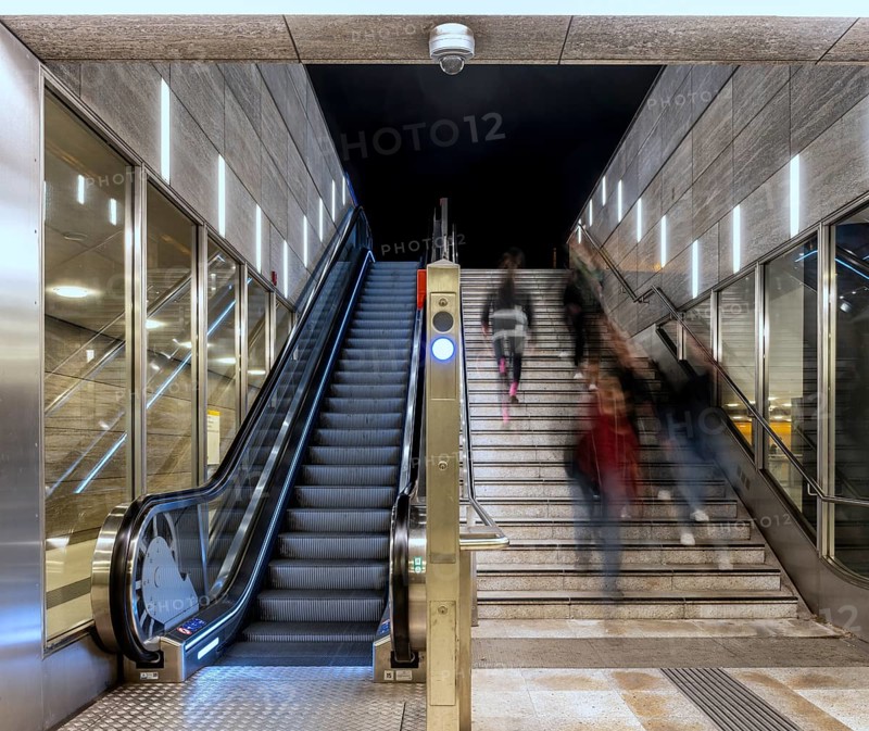 Night photo, long exposure with motion blur, modern underground entrance at Unter den Linden station, contemporary design with stairs and escalator, Berlin, Germany