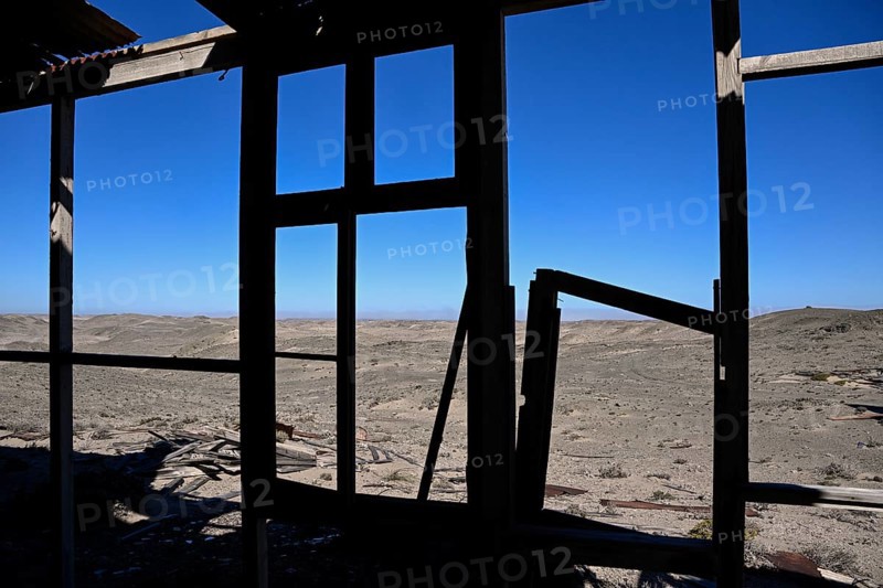 View from a dilapidated building into the desert, Pomona, restricted diamond area, near Lüderitz, Karas region, Namibia