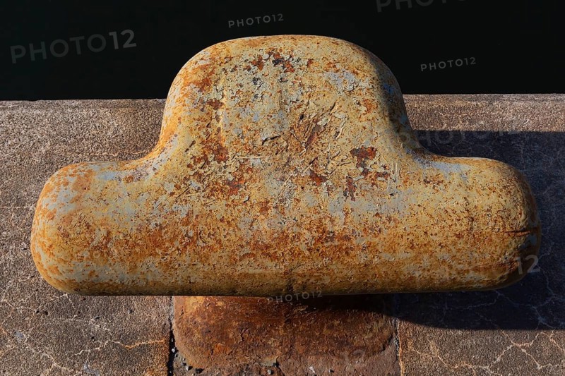 Close-up of bollard with flaking paint and rust spots on King Edward pier in Old Port of Montreal, Quebec, Canada