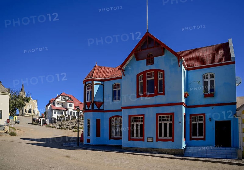 Colonial house facade in the Bergstraße, in the background the rock church, Lüderitz, Karas region, Namibia