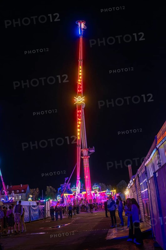 An impressive illuminated ride at a night fair, Cannstatter Wasen funfair, Stuttgart, Germany