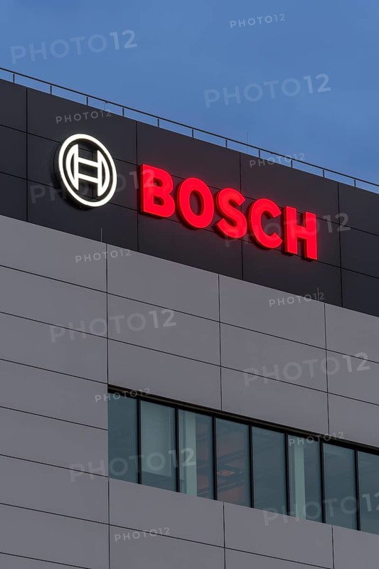 Tall grey building façade with Bosch logo and large windows at night, Waiblingen, Baden-Württemberg, Germany