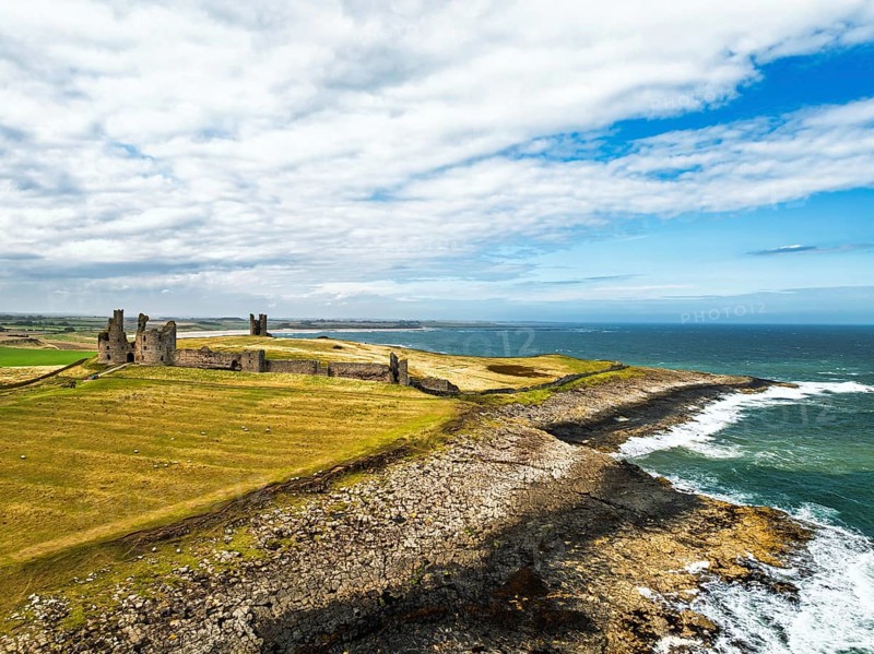 Dunstanburgh Castle from a drone, Northumberland Coast, England, United Kingdom