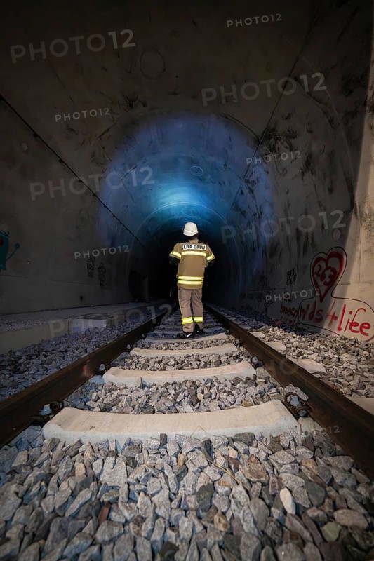 Single firefighter in illuminated tunnel on rails, firefighting exercise in the new tunnel of the Hermann Hesse railway, Ostelsheim, Calw district, Germany