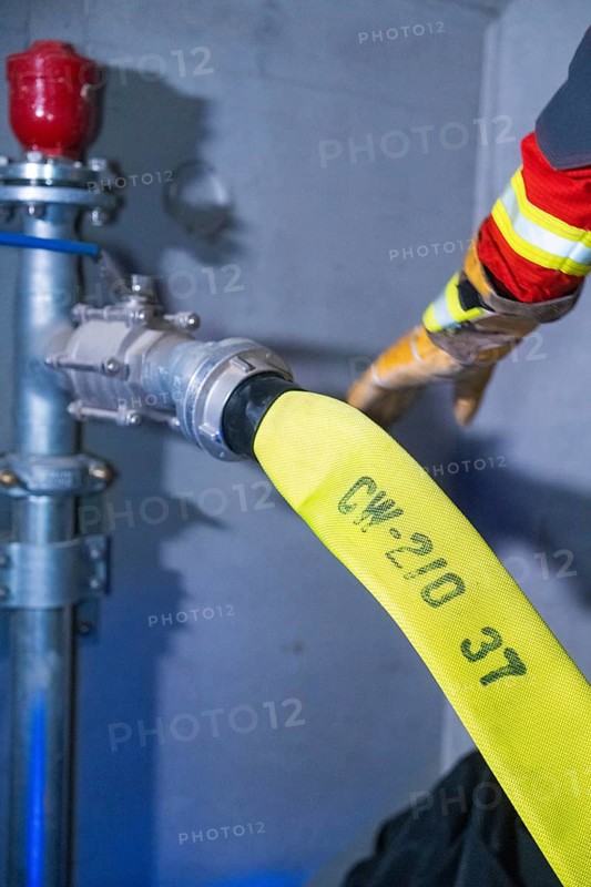 Fire hose being connected to hydrant, close-up of the connection, fire brigade exercise in the new construction tunnel of the Hermann Hesse railway, Ostelsheim, Calw district, Germany