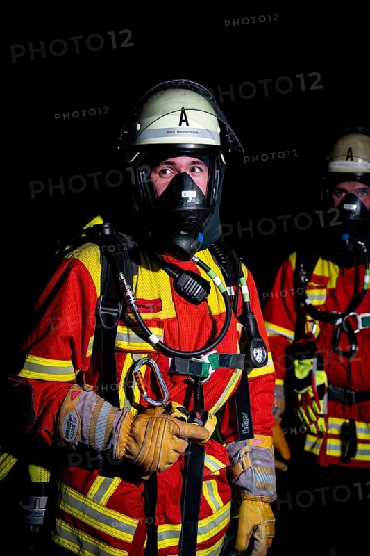 Firefighter with breathing apparatus in the dark, concentrated and ready for action, firefighting exercise in the new construction tunnel of the Hermann Hesse railway, Ostelsheim, Calw district, Germany