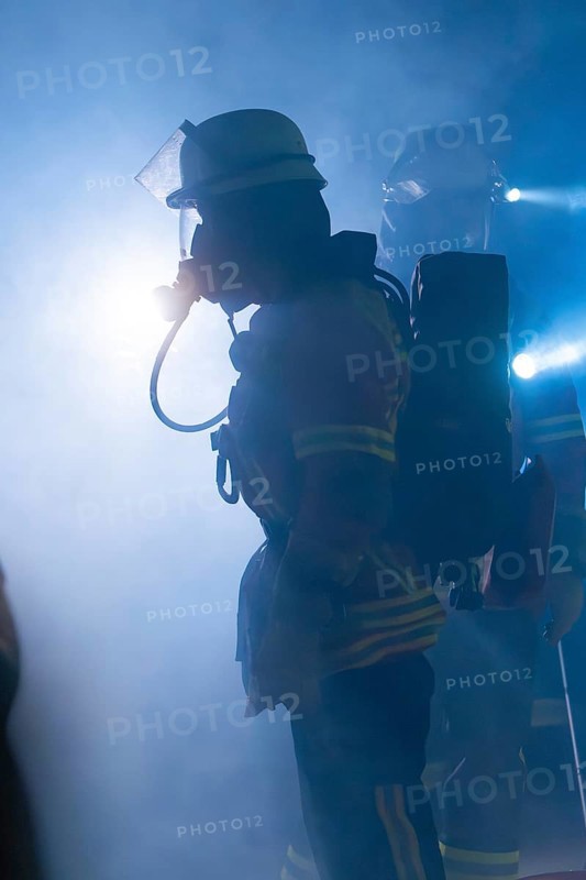 Firefighters with breathing masks in a foggy environment with bright light, firefighting exercise in the new construction tunnel of the Hermann Hesse railway, Ostelsheim, district of Calw, Germany