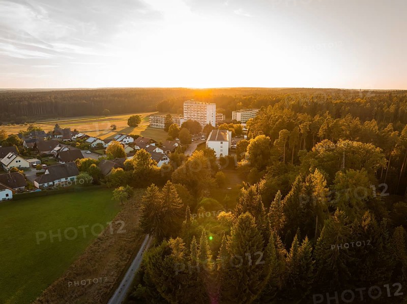 Landscape at sunset with a village and surrounding forests in warm light, fire drill in the new construction tunnel of the Hermann Hesse railway, Ostelsheim, district of Calw, Germany