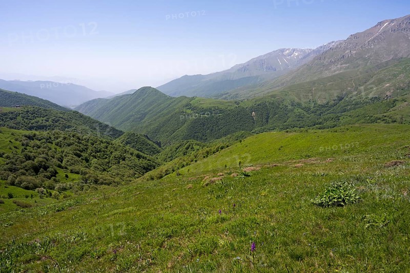 Green valley with hills and mountains under a wide sky, at the highest pass in Armenia, Meghri Pass, Tashtun Pass, Syunik Province, Syunik, Armenia