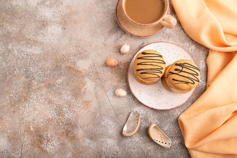 Caramel Cream Cakes on brown concrete background, cup of coffee, top view, flat lay, copy space
