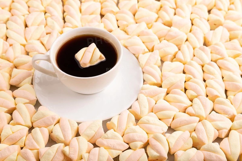 Cup of coffee on Orange and pink marshmallow background, side view, copy space, minimalism