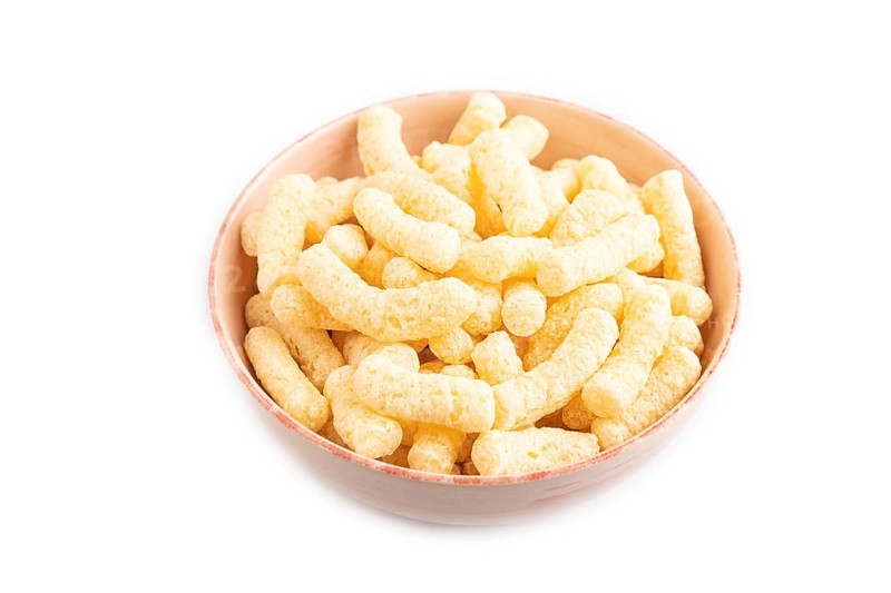 Corn flakes sticks with caramel in ceramic bowl isolated on white background. Side view, close up