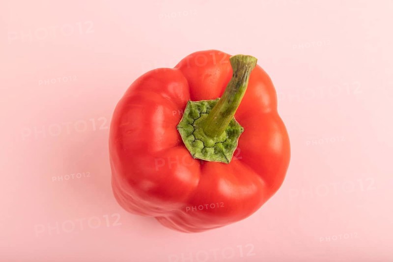 Red pepper on pink pastel background. Top view, flat lay, copy space. healthy food, vegetable, minimalism