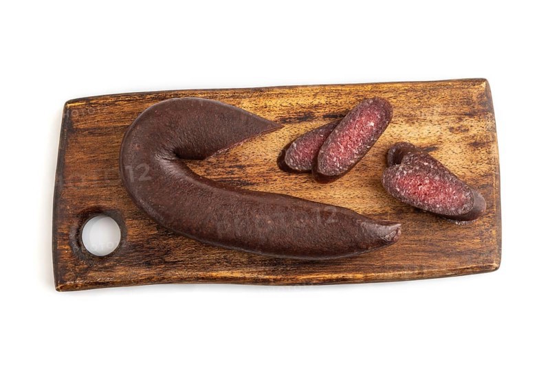 Sujuk sausage isolated on wooden cutting board on white background. Top view, flat lay, copy space