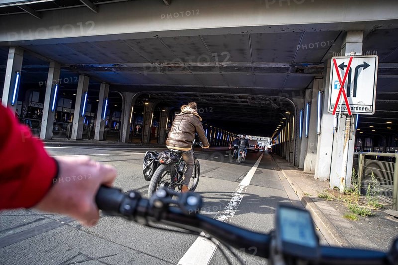 Riding a bike on a bike lane, at Essen main station, tunnel in the city centre of Essen, North Rhine-Westphalia, Germany