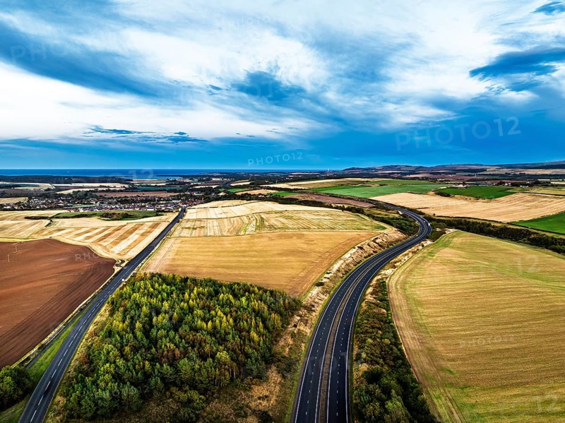 Sunset of Fields and Farms over Traprain Law and Hailes Castle from a drone, River Tyne, Haddington, East Lothian, Scotland, UK