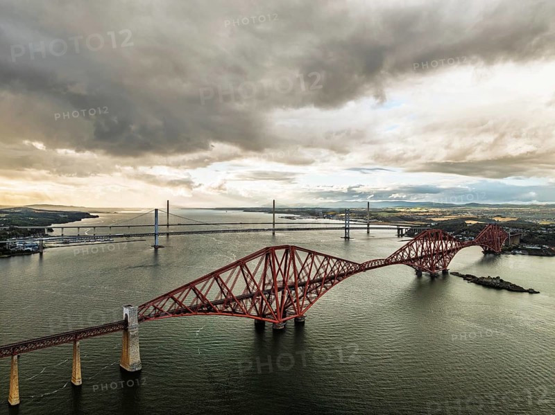 Rain clouds over Forth Bridge from a drone, Queensferry Crossing, Forth Estuary, Scotland, United Kingdom