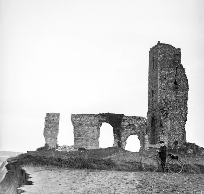 Magic lantern slide of boy with bicycle standing by ruins of All Saints church, Dunwich, Suffolk, England, UK c 1900