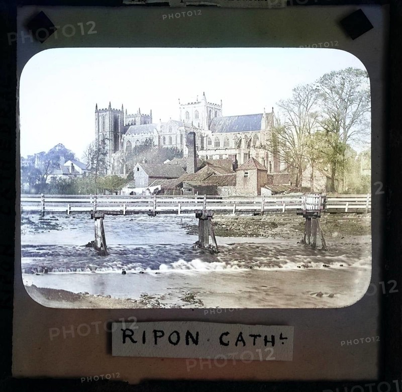 Colorised magic lantern slide of Ripon cathedral church from River Ure, Ripon, North Yorkshire, England, UK c 1900