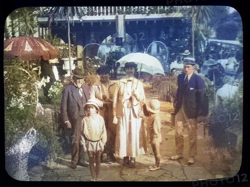 Family group standing in pleasure gardens at Karsino of Fred Karno, Tagg's Island, Molesley, London, England, UK 1920s or 1930s colourised