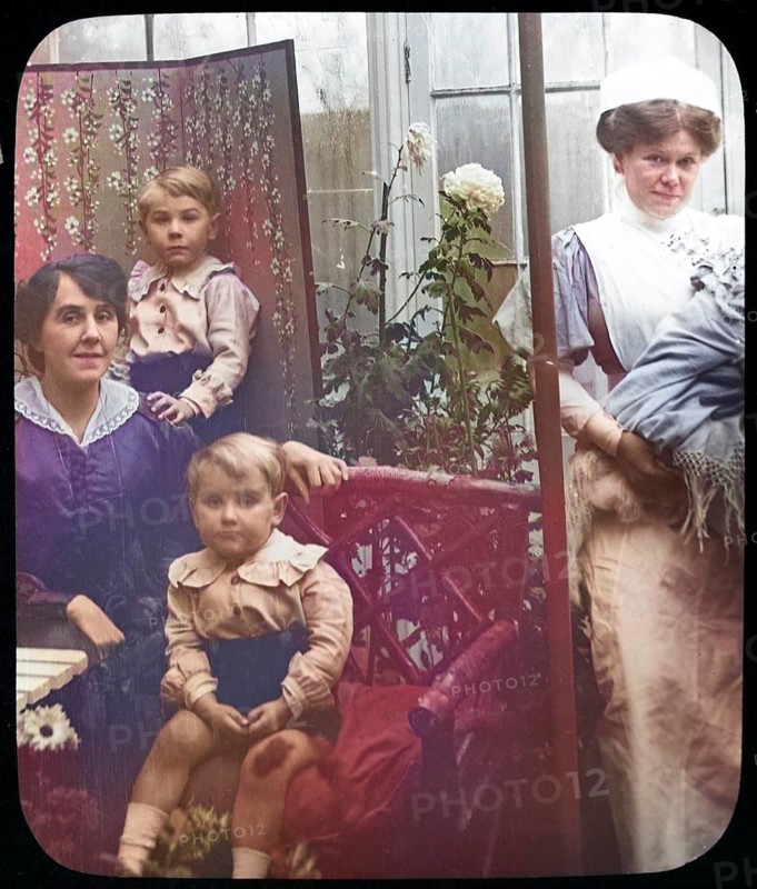 Affluent Edwardian family group indoors with children, mother, nursemaid, UK 1900 - 1930s colourised