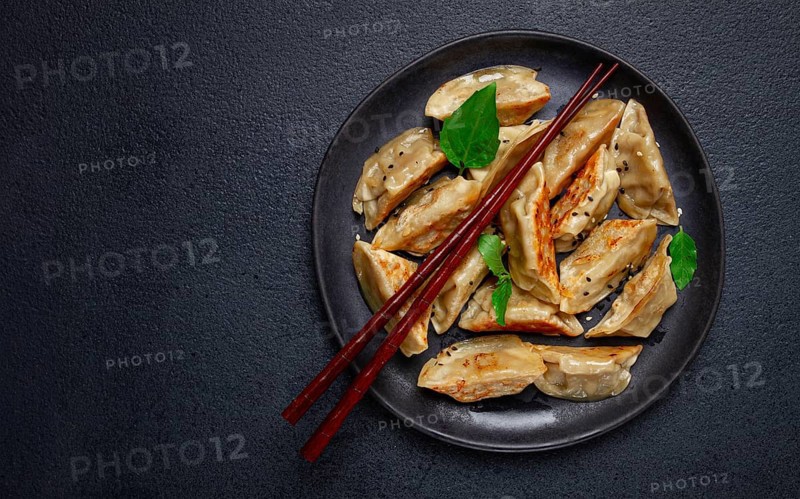 Japanese fried gyoza dumplings, with pork, sesame seeds, green onions