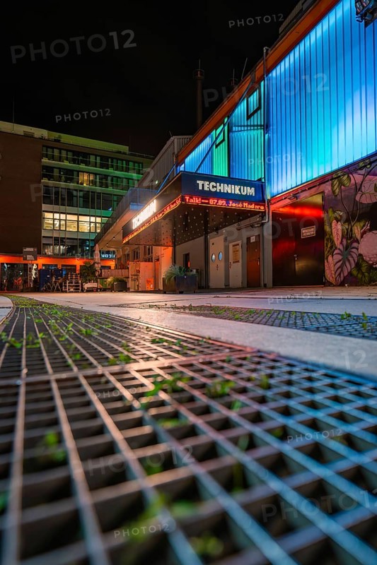 Illuminated urban scene at night with modern buildings and coloured neon lights, Tesla Model Y Juniper, Gechingen, Black Forest, Germany
