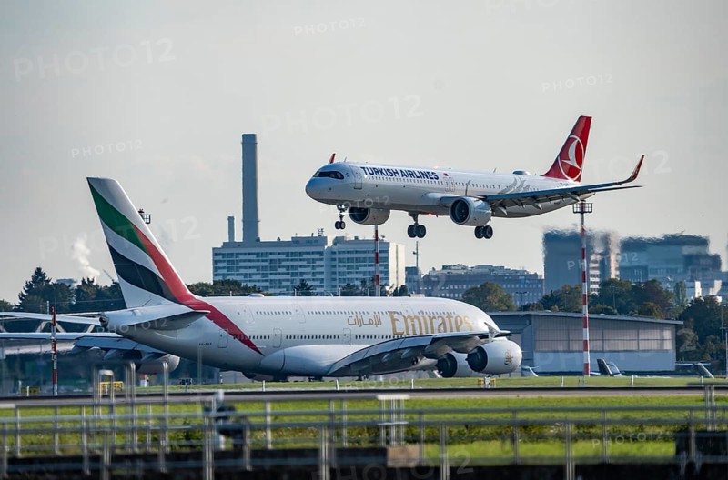 Turkish Airlines Airbus A321neo lands at Düsseldorf Airport, Emirates Airbus A380 taxis for take-off, North Rhine-Westphalia, Germany