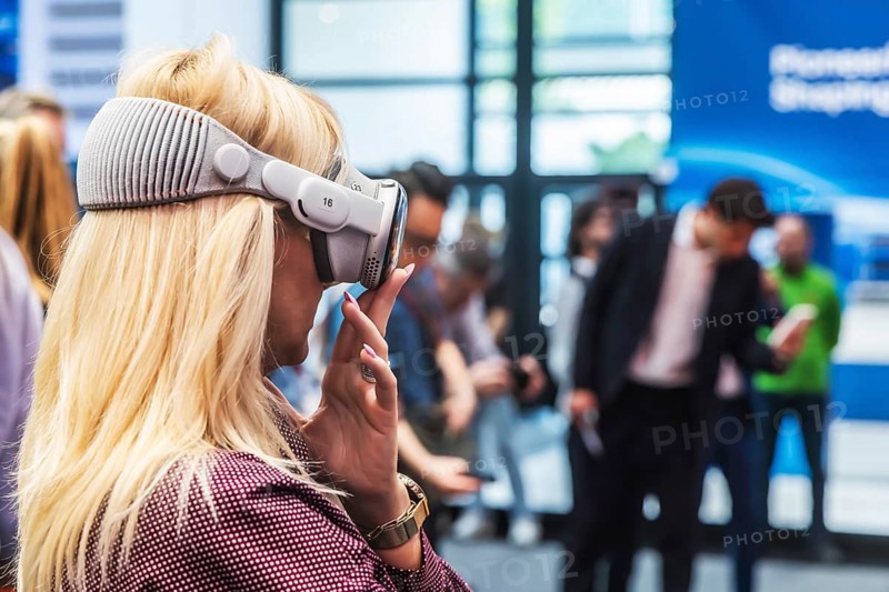 Mercedes exhibition stand. The Virtual Ride. Trade fair visitor with 3D glasses. IAA MOBILITY in Munich. The motor show presents itself as a holistic mobility trade fair. Cars continue to take centre stage, however, and Chinese manufacturers are gaining ground. Munich, Bavaria, Germany