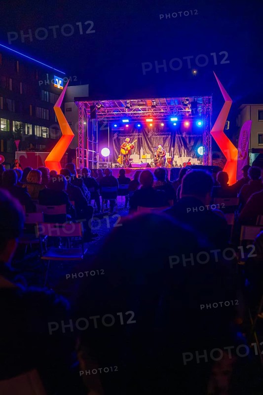 Concert at night on a colourfully illuminated open-air stage with audience, Feuernacht, Sindelfingen, Germany