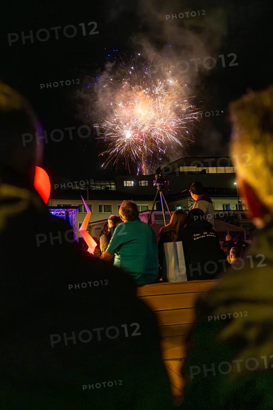 Group of spectators watching fireworks in the night sky above a building, Fire Night, Sindelfingen, Germany