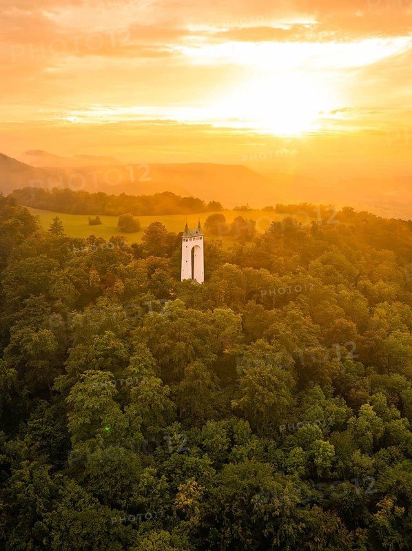 Tower in the middle of a forest under an orange-coloured sky at sunset, Schönberg Tower, Pfullingen, Swabian Alb, Germany