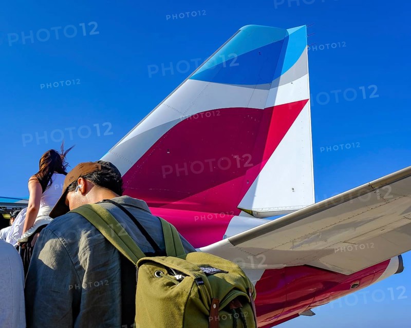 Mykonos, Greece - EUROWINGS. At Mykonos Airport, holidaymakers board a Eurowings aircraft via an external staircase on the apron