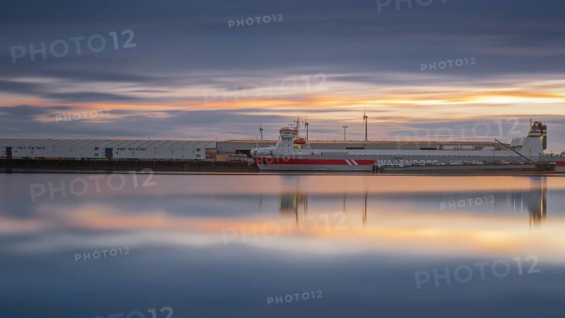 View of a ship moored at the quay in Neustadt harbour at sunset, long exposure, Weser, Bremen, Germany