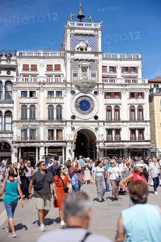 Venice, Italy - 3 September 2025: Tourists at the clock tower of San Marco on St Mark's Square in Venice during the 82nd Venice International Film Festival