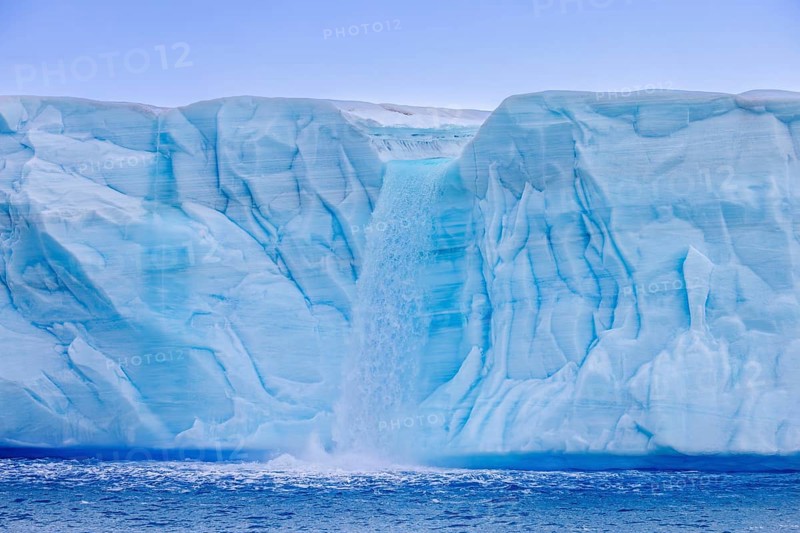 Waterfall at edge of the Brasvellbreen glacier from the ice cap Austfonna debouching into the Barents Sea, Nordaustlandet, Svalbard, Spitsbergen