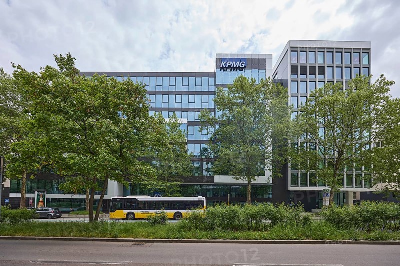 Auditing and management consultancy KPMG, modern architecture, street, public bus, trees, milky blue sky, diffuse light, Theodor-Heuss-Straße, Stuttgart, state capital, urban district of Stuttgart, Baden-Württemberg, Germany